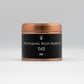 A dad candle with a black label in a copper tin, scented with Honey & tobacco made with soy wax